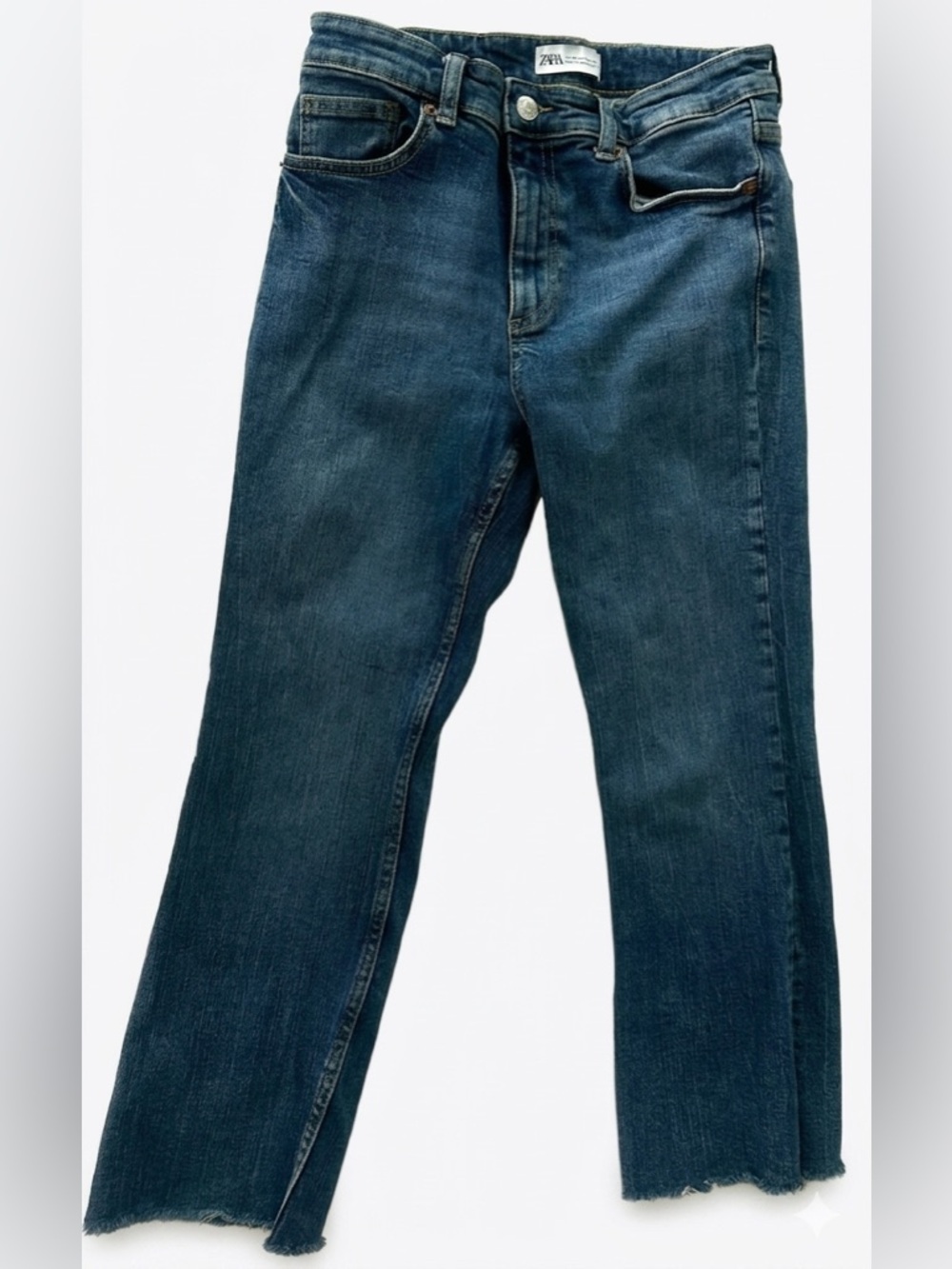 Zara women’s flared jeans featuring a distinct raw, frayed hem. Size 6.